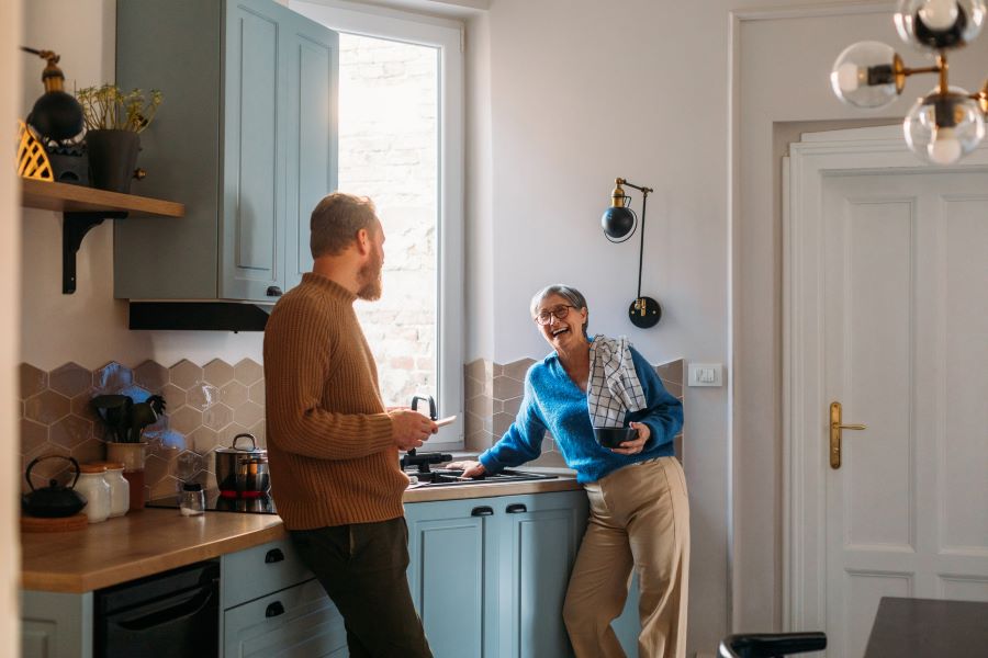 Man And Woman Laughing In Kitchen